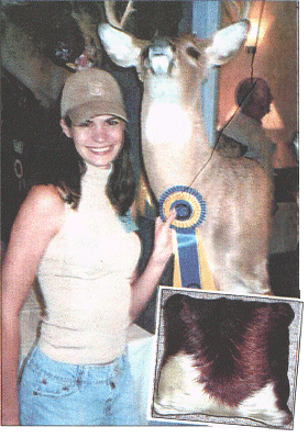 Target:Jeanette Hall smiles next to a stuffed stag and,inset,one of her controversial pillows [Pictures Splash News]